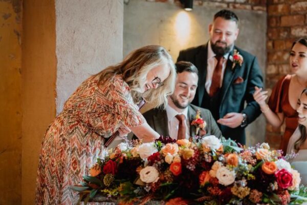 Bride and Groom sign their marriage paperwork with Stefanie Onipko Humanist Celebrant at the Wool Tower.